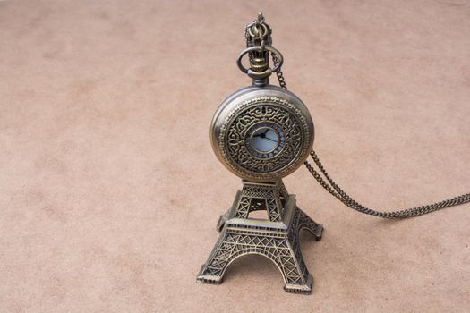 Little model Eiffel Tower  and a pocket watch 