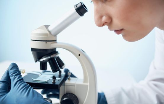 microscope research medical gown woman doctor gloves laboratory