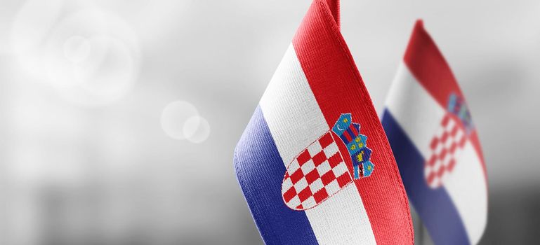 Small national flags of the Croatia on a light blurry background