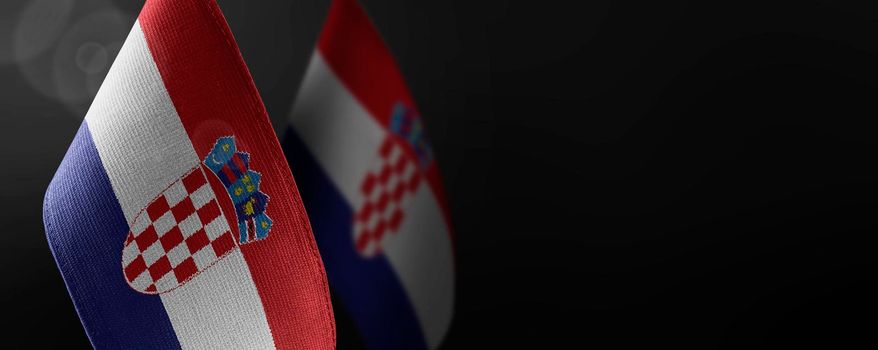 Small national flags of the Croatia on a dark background