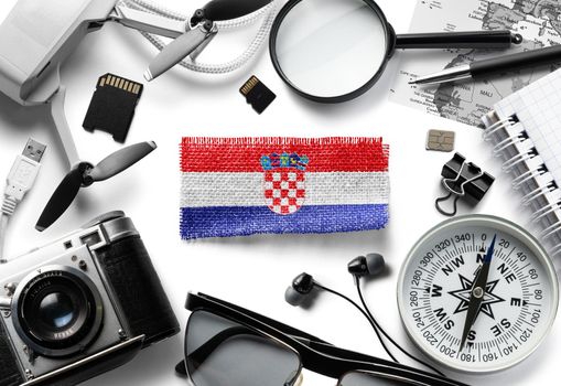 Flag of Croatia and travel accessories on a white background.