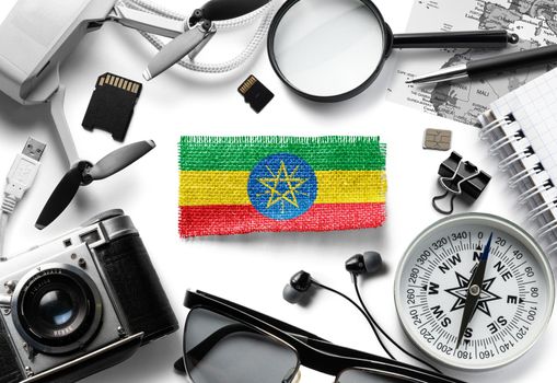 Flag of Ethiopia and travel accessories on a white background.