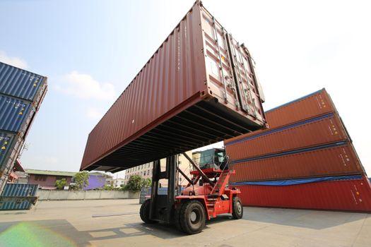 Foreman control loading Containers box from Cargo freight ship for import export. Container Warehouse Worker.