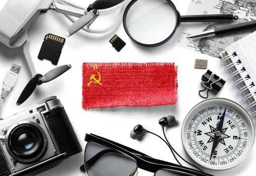 Flag of USSR and travel accessories on a white background.