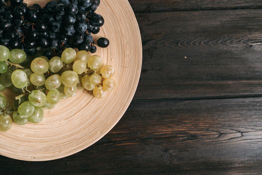 grapes on a plate wooden background fruit freshness