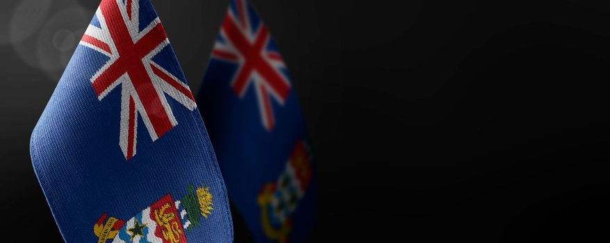 Small national flags of the Cayman Islands on a dark background