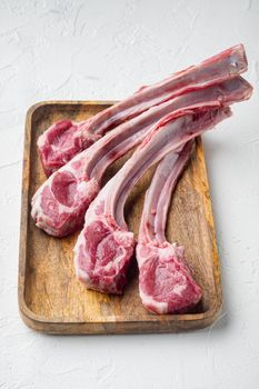 Raw lamb chops or mutton cuts, on white stone background