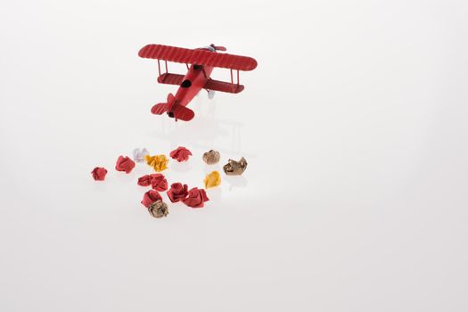 Red airplane and crumpled paper