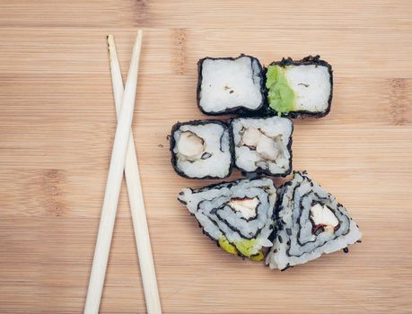 sushi rolls chopsticks food ration delicacy wood board japanese cuisine. High quality photo
