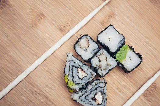 sushi rolls chopsticks food ration delicacy wood board