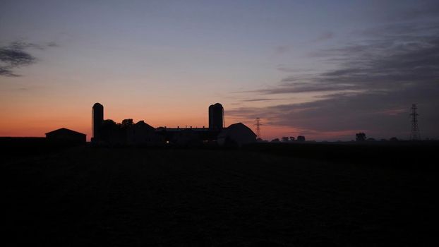 Sunrise Looking over an Amish Farm with Farm House Barn and Silos