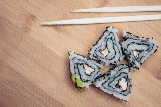sushi rolls chopsticks food ration delicacy wood board