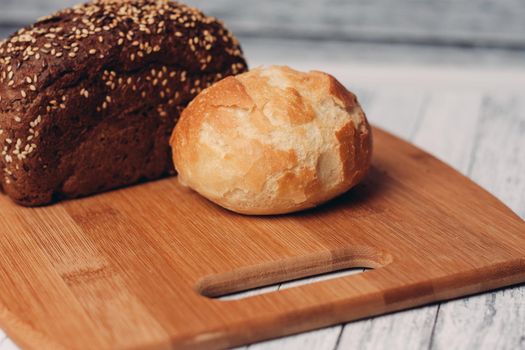 loaf of bread on a wooden board powerful products food