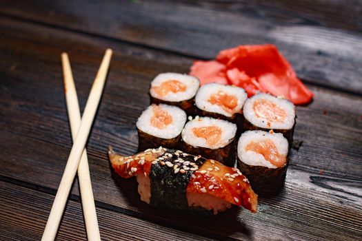 seafood sushi rolls wooden sticks japanese tradition ginger wasabi