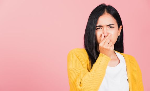 woman unhappy what a smell disgust expression squeezing nose with fingers