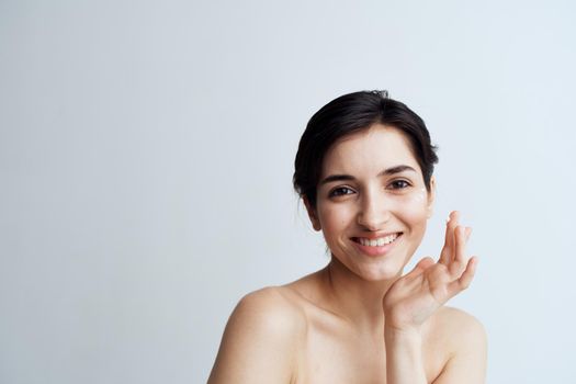 Beautiful brunette clean skin care face dermatology cream