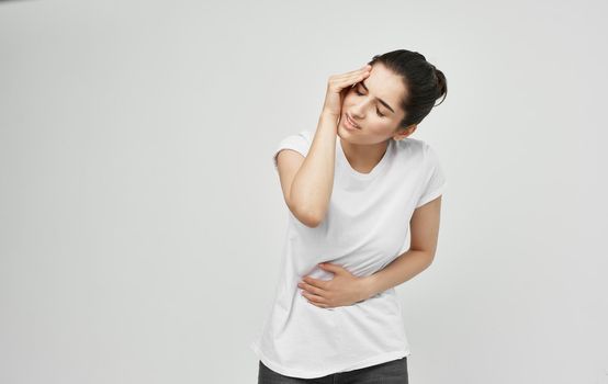 woman in white t-shirt health problems body pain discomfort