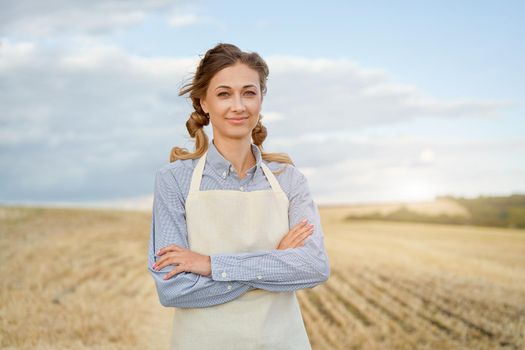 Woman farmer apron standing farmland smiling Female agronomist specialist farming agribusiness Happy positive caucasian worker agricultural field