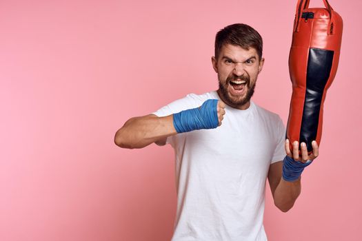 Sports man White T-shirt punching bag exercise gym