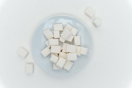 refined sugar cubes on a plate energy calories