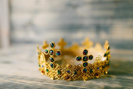 Golden crown encrusted with precious stones for wedding in church