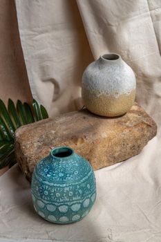 Two handmade ceramic vases on white textured table cloth. Home decor, Copy space, Selective focus.
