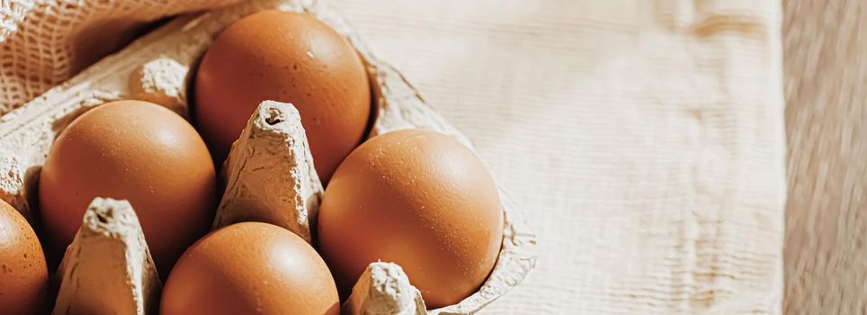 organic farm eggs in egg box and rustic cloth napkins