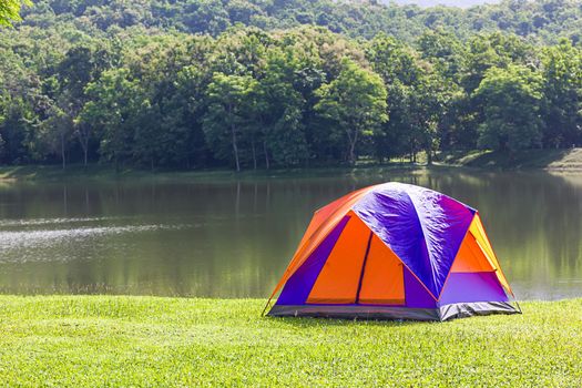 Tourist dome tent camping at lake side in forest camping site