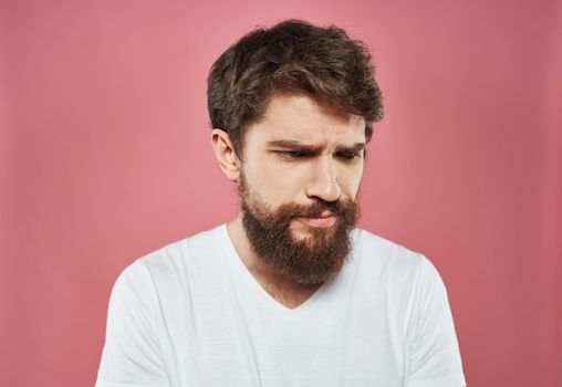 Man emotions sadness white t-shirt pink background