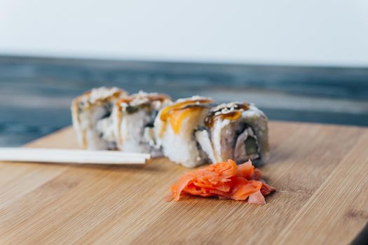 sushi rolls chopsticks see wood board food assortment