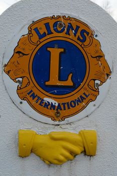 SMITHS FALLS, ONTARIO, CANADA, MARCH 10, 2021: A closeup view of the logo and handshake emblem of the Lions Club Monument made of stone found along the Victoria Park pathway located in small town Smiths Falls.