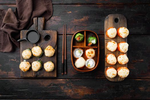 Japanese sushi rolls named Baked Ebi with wasabi and salmon fish, on old dark wooden table background, top view flat lay