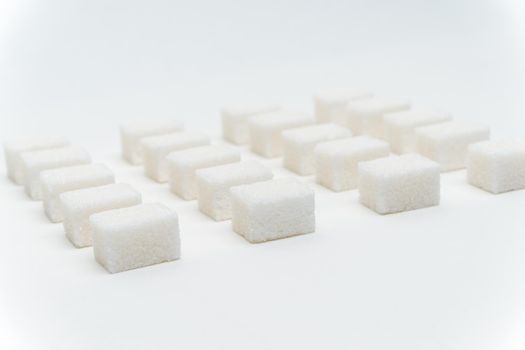 sugar cubes evenly spaced sweets ingredient light background