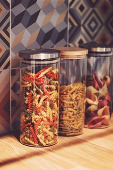 Pasta in dry food storage containers in the kitchen, pantry organisation and home decor