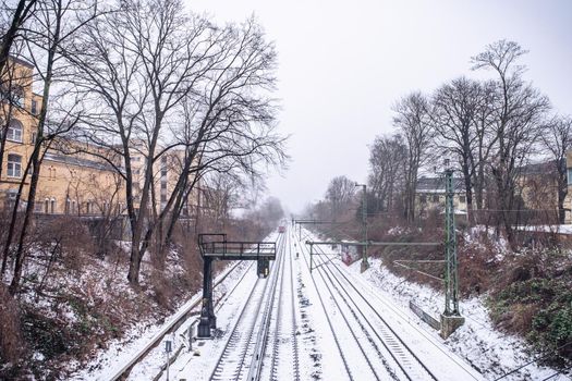 View of the rails in the snow from the bridge in Hamburg in winter