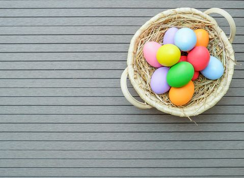 Easter eggs in the basket on wood