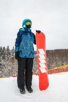 Person with a snowboard on the ski resort