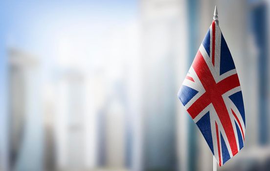 A small flag of United Kingdom on the background of a blurred background
