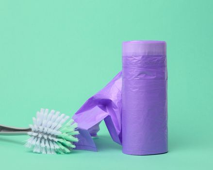 skein of purple plastic trash bags with strings on a green background