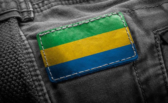 Tag on dark clothing in the form of the flag of the Gabon
