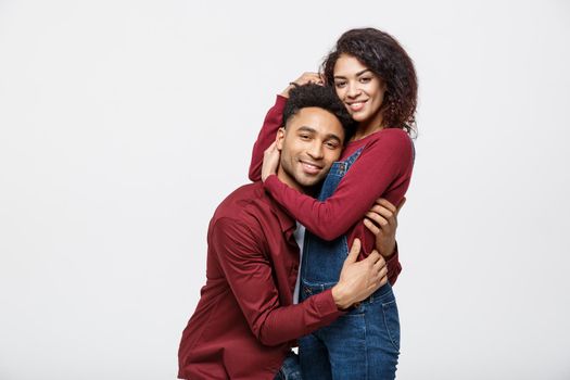 portrait of happy african american couple hug each other on white background.