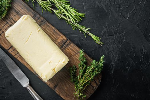 Rustic farmhouse inspired butter, on black background, top view flat lay