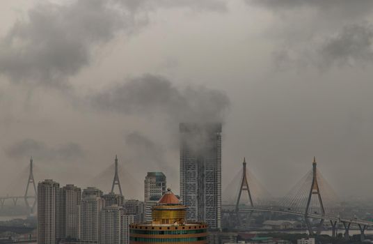 PM 2.5 or Heavy smog was covered the Bangkok building the morning.There are air pollution under heavy cloud.