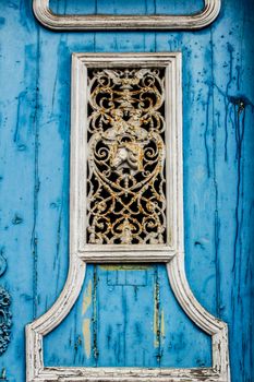 Old colorful wooden door with forged metal details