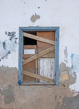 Old wooden boarded up window in abandoned egyptian house