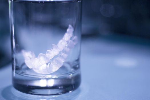 Transparent tooth aligner inside a crystal glass