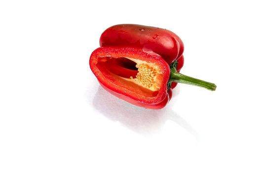 Red bell pepper in a cut on a white background. Isolate. Foreground.