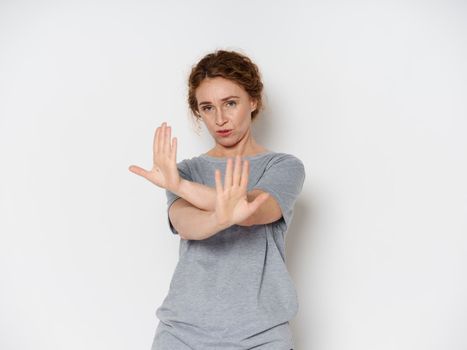 Elderly woman shows negative gesture with hands