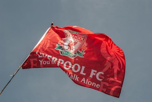 Liverpool F.C. Flag waving with the blue sky background.