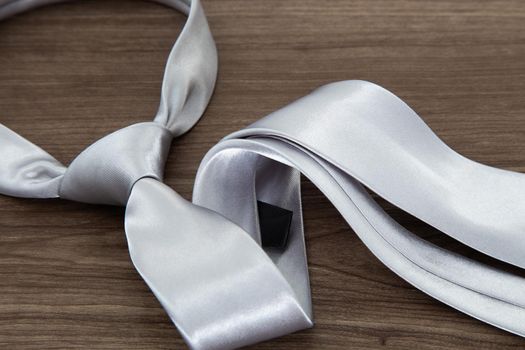 Silver color necktie on table